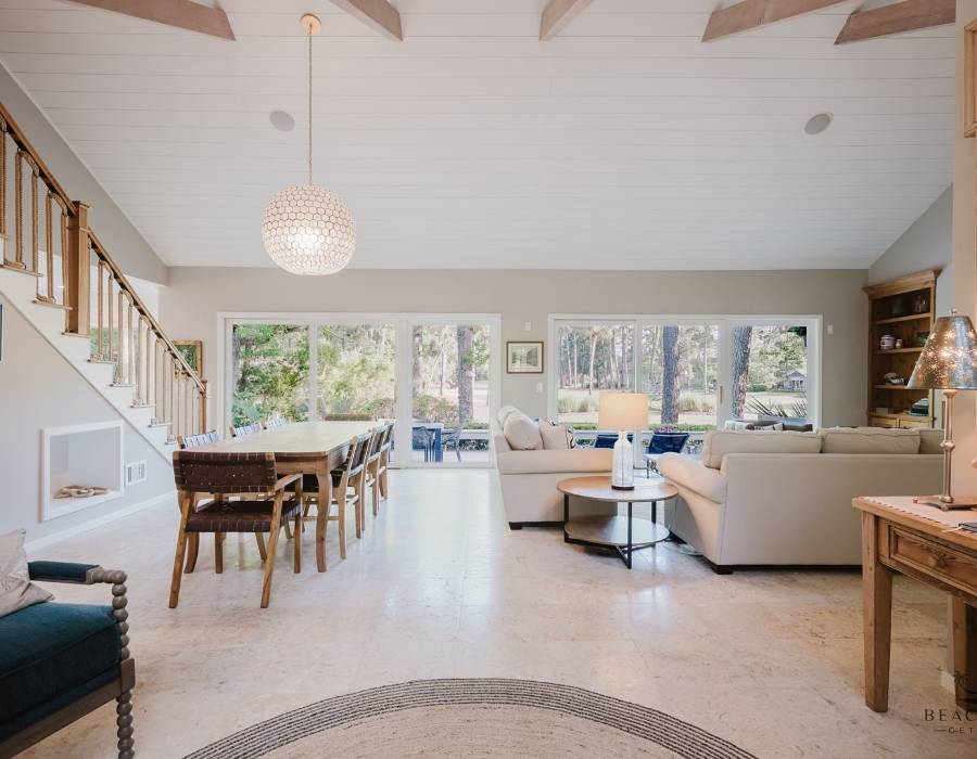 Bright and airy open-concept living and dining space at 67 Plantation Drive vacation rental in Hilton Head, featuring vaulted ceilings, large windows, and comfortable seating for big groups