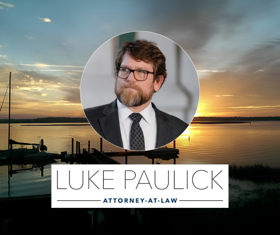 Portrait of an attorney above the Luke Paulick Attorney-at-Law logo with a coastal sunset marina background.